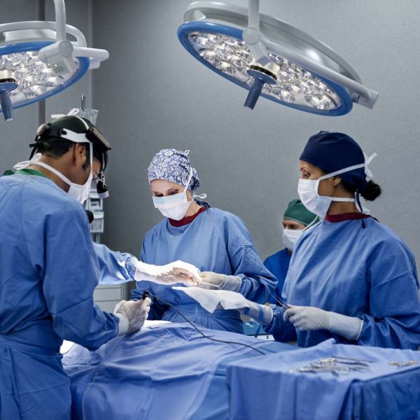 surgeon-operating-patient-on-table-at-hospital-695465248-594d78063df78cae8102d5bd